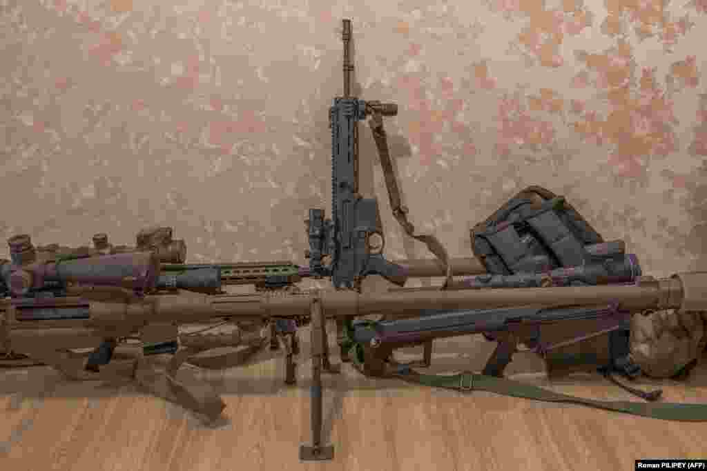 Оружие снайперского отряда. Командир подразделения, одетый в футболку с надписью "Призраки Бахмута", говорит, что на счету его команды 558 пораженных целей