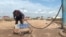 Kazakhstan -- a local resident of Astana fills bottles with water because of the lack of public infrastructure