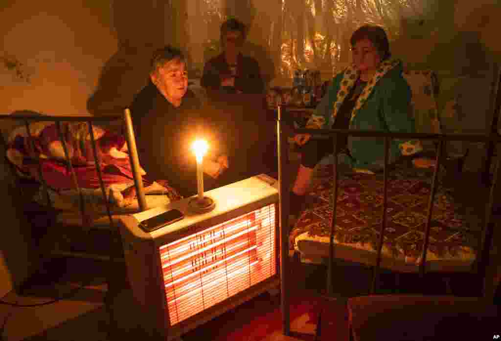 Women take refuge in a bomb shelter in Nagorno-Karabakh&#39;s main town of Stepanakert (Khankendi) on October 8, 2020. Aside from hitting civilian buildings in the town, shelling by Azerbaijani forces has periodically disrupted the town&#39;s electricity supplies.&nbsp;Nagorno-Karabakh human rights ombudsman Artak Beglaryan has reported 31 civilian deaths and hundreds wounded, according to the Associated Press.&nbsp;
